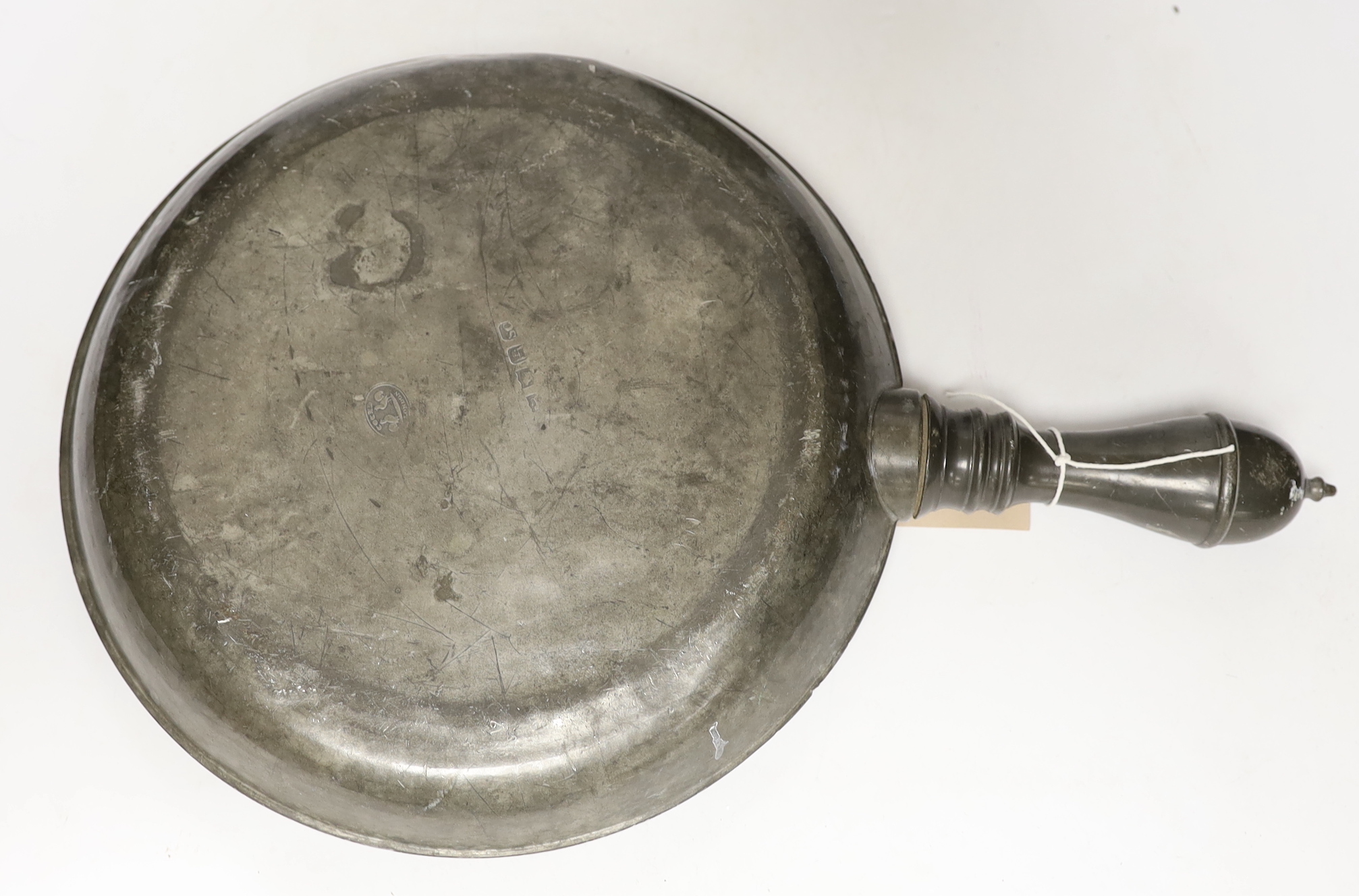 An 18th/19th century pewter measure and an 19th century pewter pan, 46cm long